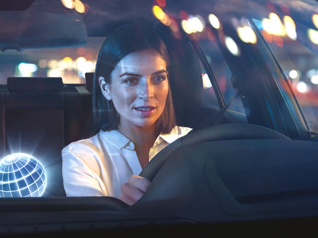 Detail of a woman behind the steering wheel of a BMW