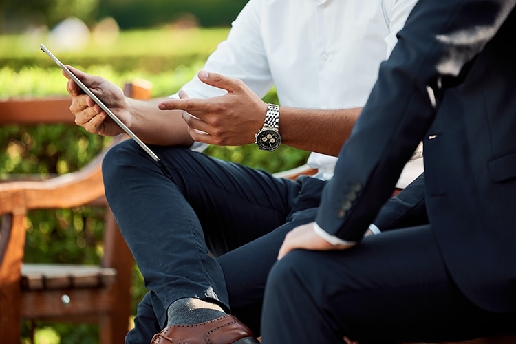 Two people sharing information via digital device