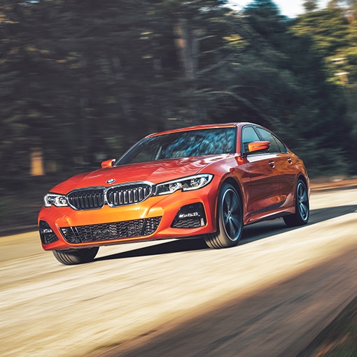 A 2022 BMW 330i xDrive driving down a scenic highway