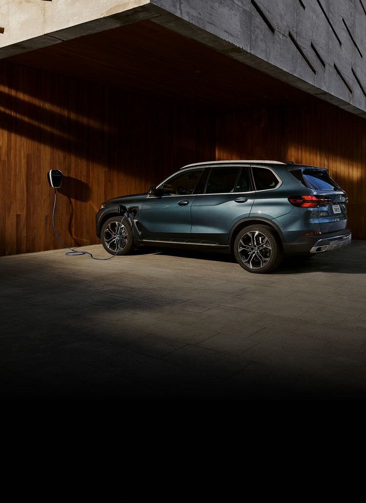 A 2024 BMW X5 xDrive50e charges at home with the BMW Wallbox charger.