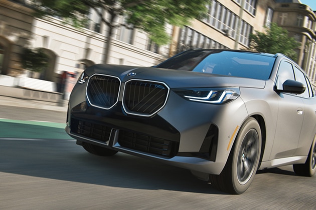 A dramatic close up on a BMW conquering a city street