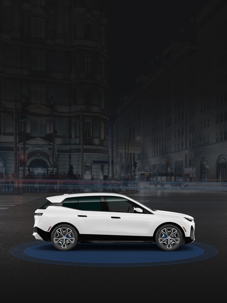 Side view of the 2025 BMW iX xDrive50 set on blue circles representing safety sensors