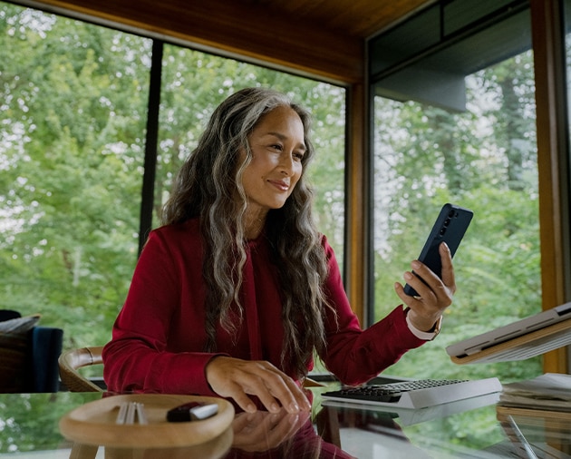 A driver uses their smartphone to check for Remote Software Upgrade notifications