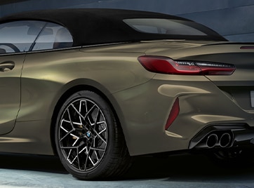 A 2025 BMW M8 Competition Convertible with retractible soft top deployed