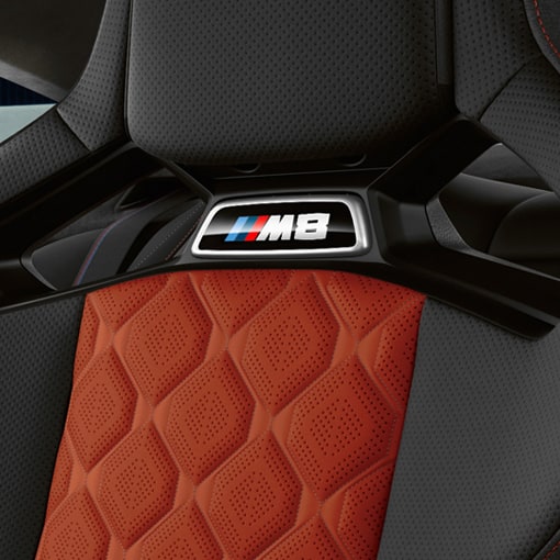 Detail of M badged seats with Black Full Merino Leather and Sakhir Orange Alcantara Cloth