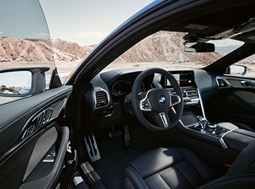 Detail of 8 Series Coupe's driver side door open to reveal cockpit interior