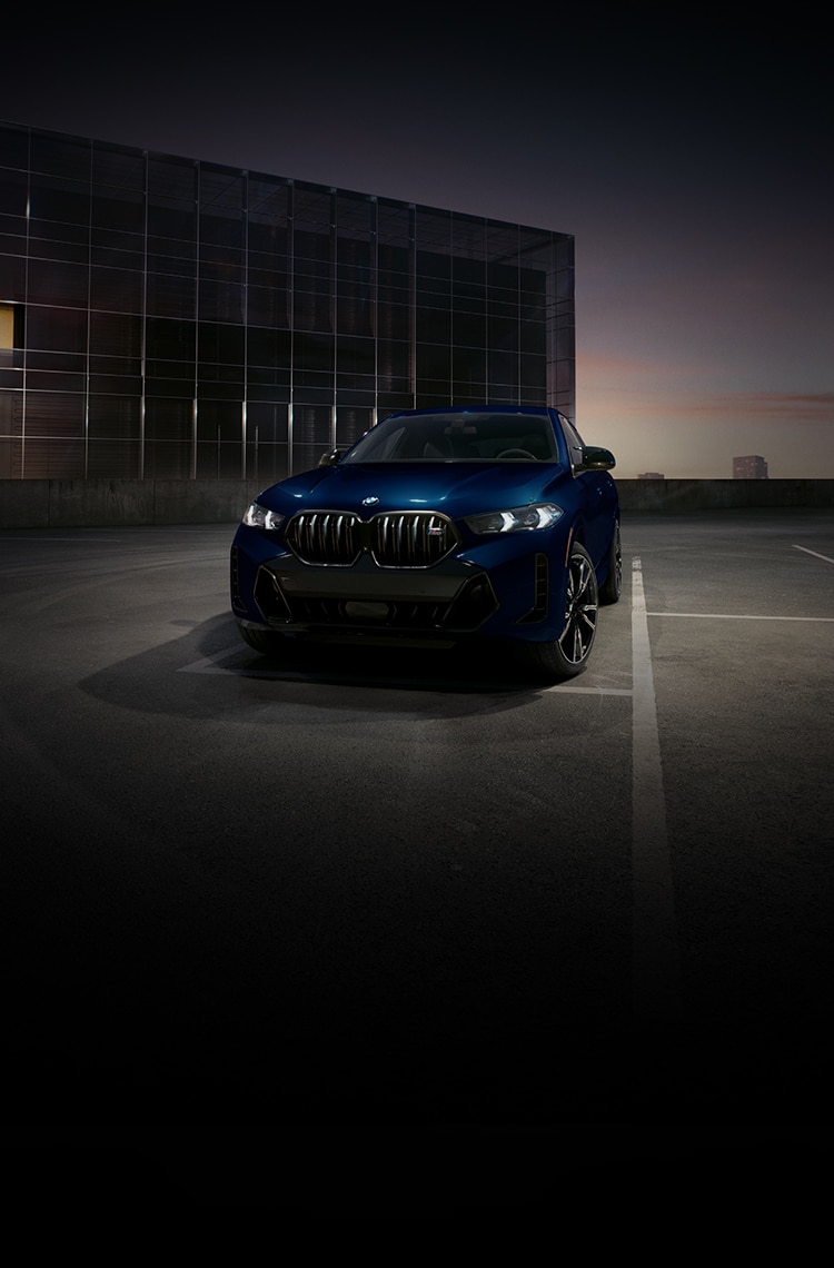 The 2026 BMW X6 M60i Coupe SUV parked in an urban parking lot