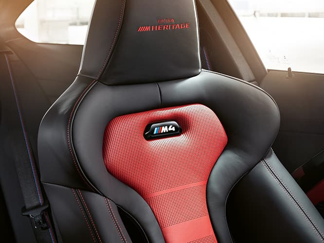 Black Merino Leather seats with red contrast stitching and M4 Edition M Heritage embroidery