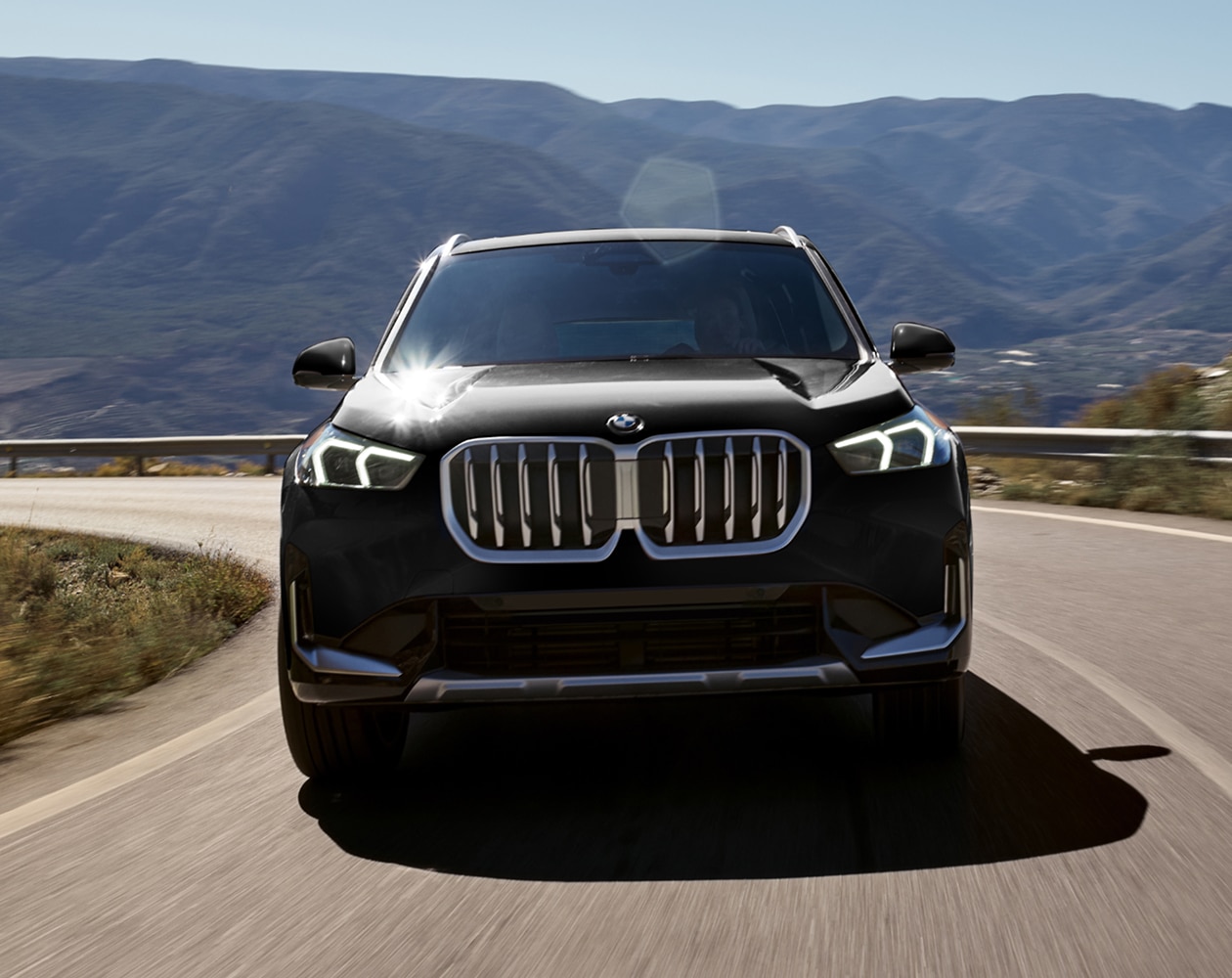 Dynamic shot of the BMW X1 driving on the road